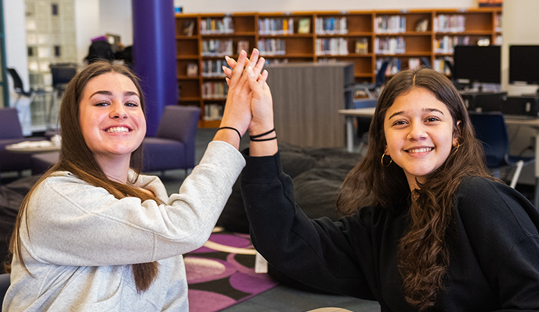 two students in a high five